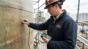 AFTR certified inspector performing ultrasonic thickness testing on fiberglass tank
