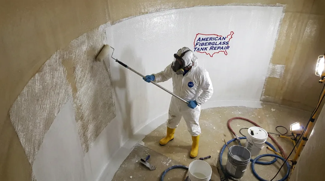 AFTR technician performing FRP tank relining and corrosion barrier restoration inside tank