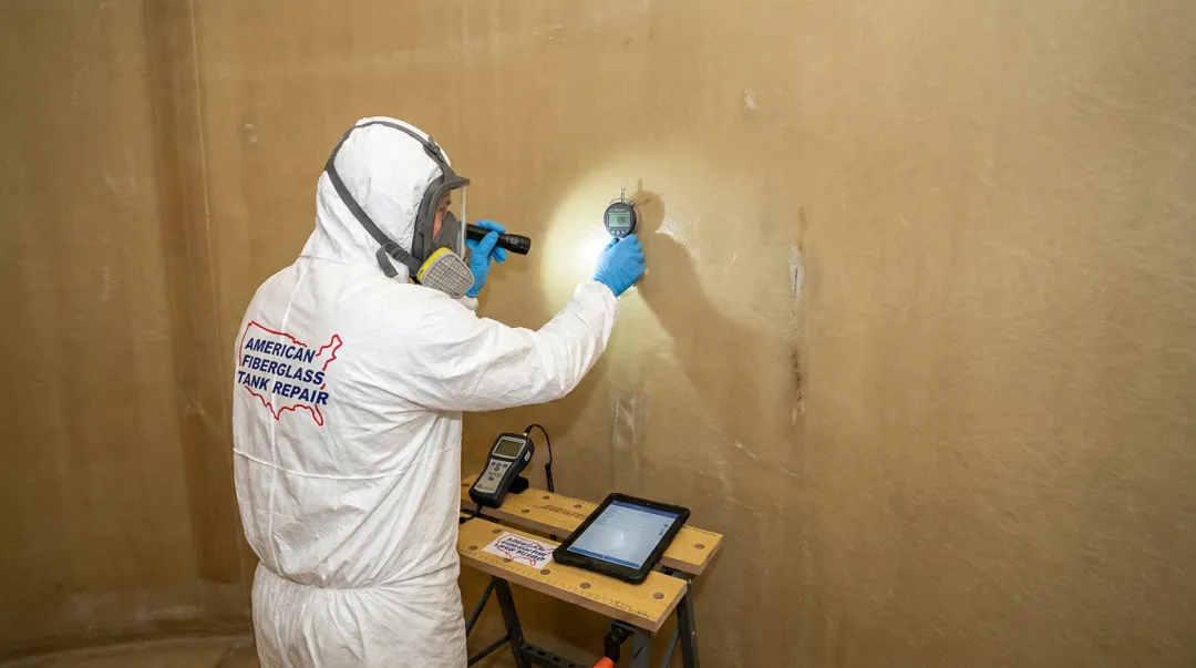AFTR certified inspector assessing FRP tank interior corrosion liner condition
