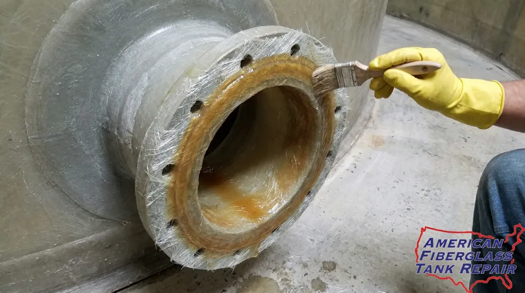 FRP tank nozzle connection inspection showing laminate repair and sealing process