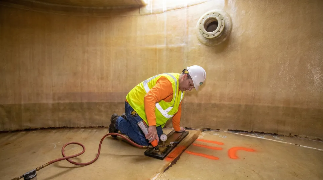 FRP tank interior inspection showing corrosion barrier liner condition and nozzle penetrations