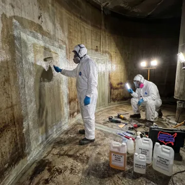FRP tank repair crew inspecting a wastewater vessel