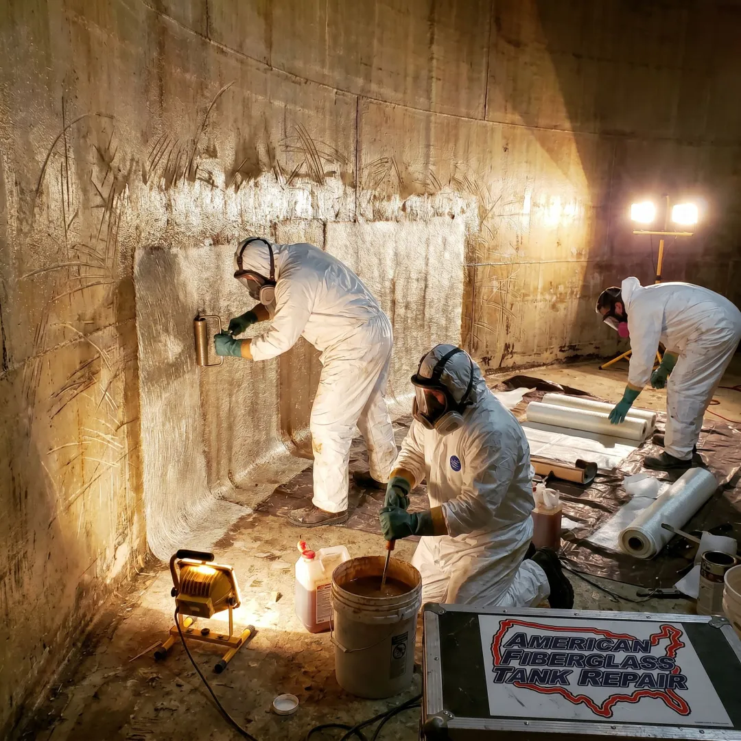 FRP tank repair crew preparing laminate work