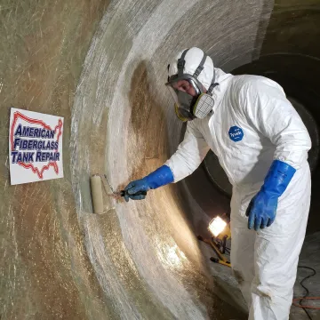 Technician recoating the inside of an FRP tank