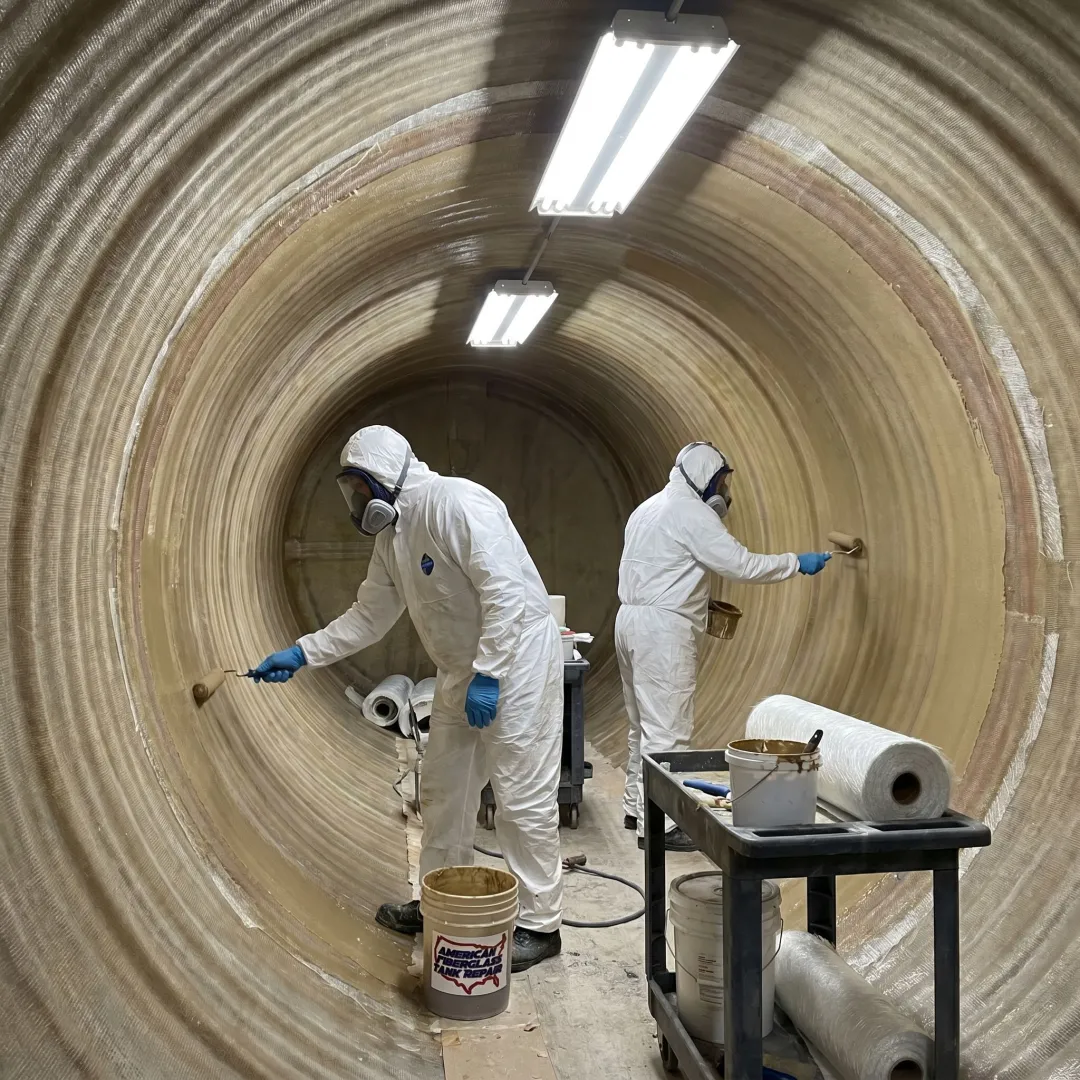 Technicians relining an FRP tanker trailer interior