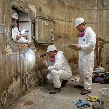 FRP tank repair crew inspecting a storage tank