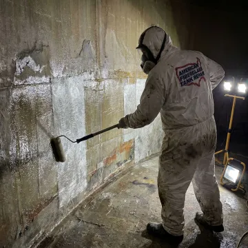 Technician repairing an FRP fuel storage tank