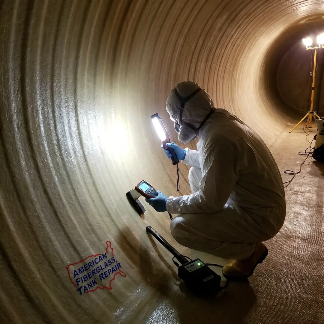 Technician inspecting fiberglass water storage tank lining