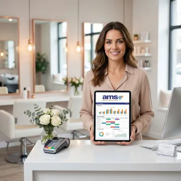Salon owner reviewing integrated POS and accounting dashboard on a tablet at their front desk