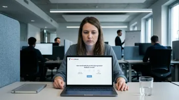 Disengaged employee declining workplace survey on laptop in office setting