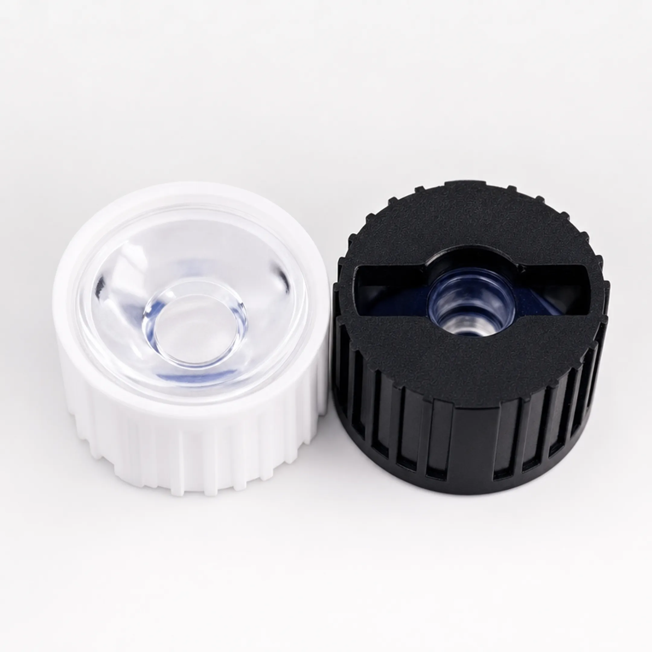 Precision polymer optic lens components for LED emergency lighting fixtures