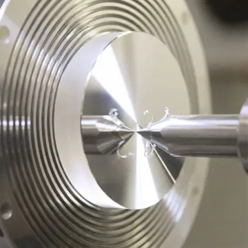 Close-up view of diamond turning tool creating precise optical surface