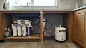 AquaGuard 9-Stage reverse osmosis system installed under kitchen sink Houston home