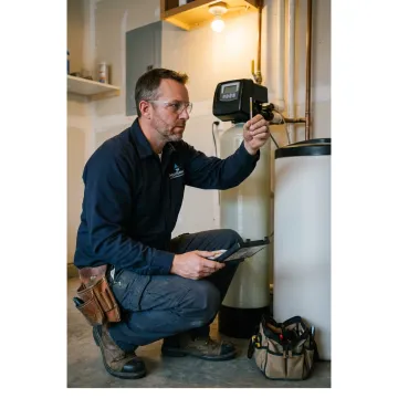 Technician testing water softener performance