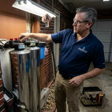 Technician testing water treatment equipment