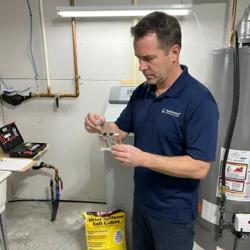 Technician testing water before softener installation