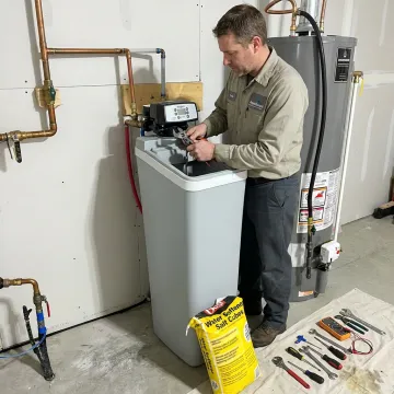 Water softener system being serviced by a technician