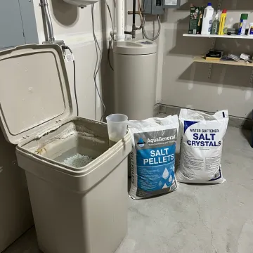 Water softener salt bags delivered beside a brine tank