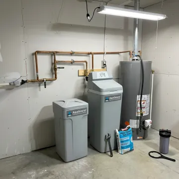Modern home water softener system installed in a utility room