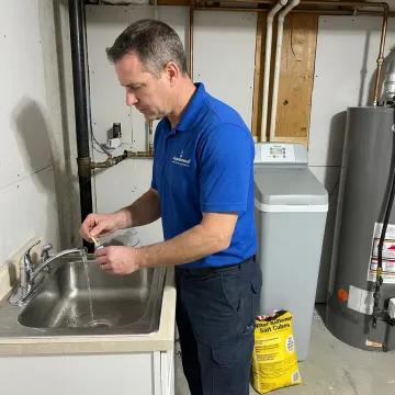 Technician testing home water before filter installation