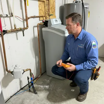 Water treatment specialist inspecting a home filtration system
