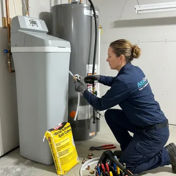 Technician installing a residential water softener system