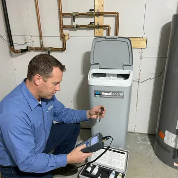 Technician testing water beside a home water softener