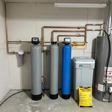 Private well water filtration system installed in a home