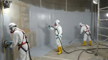 AmTech tank relining crew applying NSF-compliant epoxy lining inside large industrial water tank