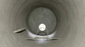 Underground steel tank interior showing full cementitious lining application and surface coating
