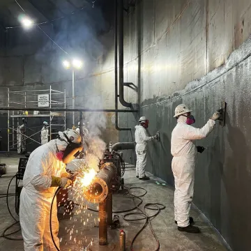 Chemical storage tank repair crew working on industrial tank in Houston facility
