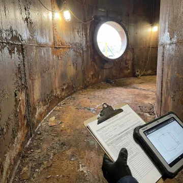 Close-up of fire water tank interior showing coating condition and steel substrate