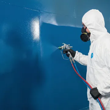 Close-up of DuraChem polylining being spray-applied to industrial tank interior