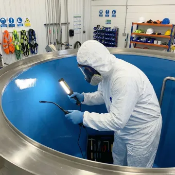 Professional technician repairing a hot water storage tank in Mooresville, NC