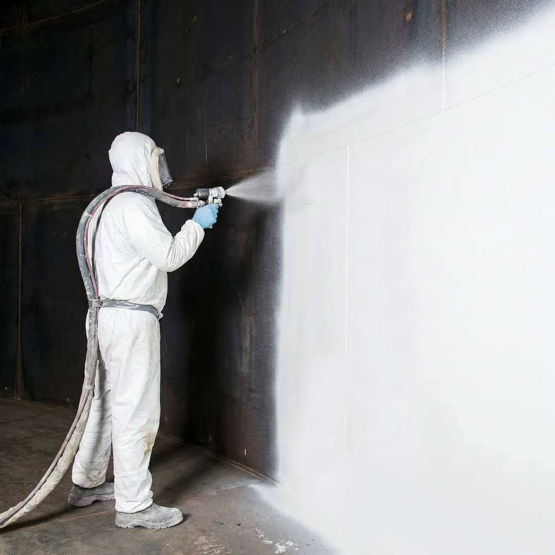 Close-up of technician applying instant-cure polylining to repair water tank leak