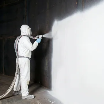 Close-up of technician applying instant-cure polylining to repair water tank leak
