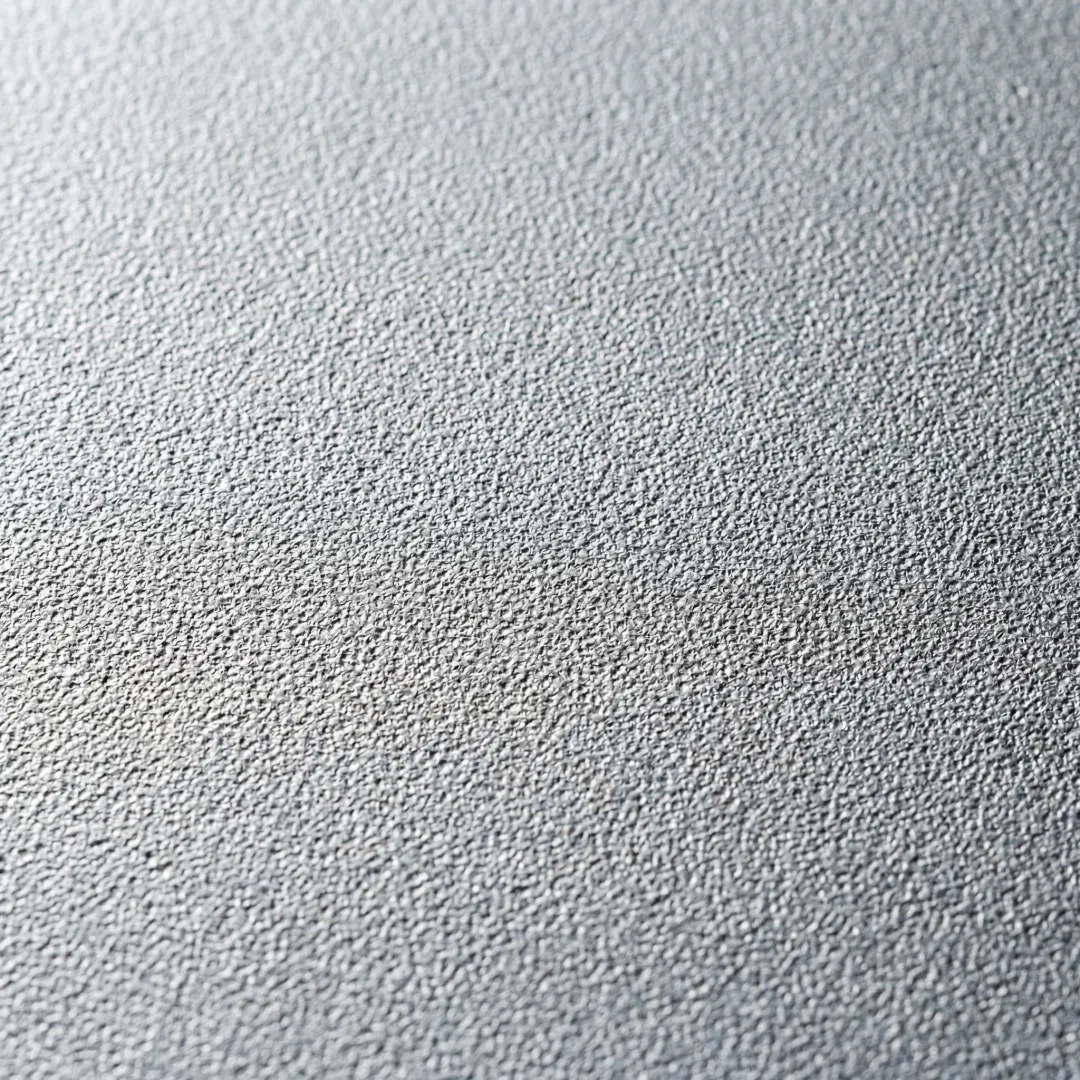 Close-up of sandblasted steel tank surface showing uniform blast profile