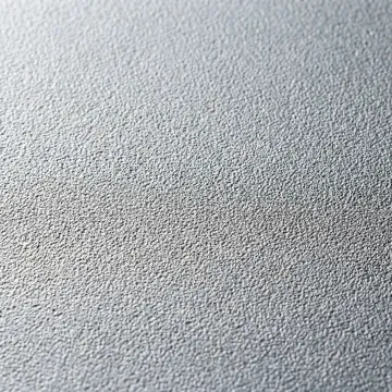 Close-up of sandblasted steel tank surface showing uniform blast profile