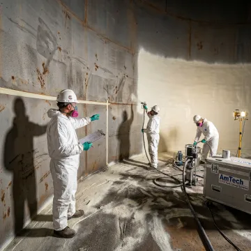 Crew restoring a fire suppression tank lining