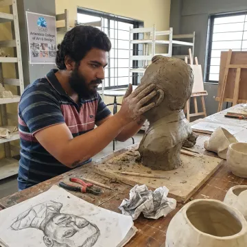 Ceramic sculpture student working with clay