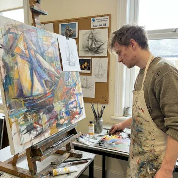 Artist developing a conceptual painting in a postgraduate studio