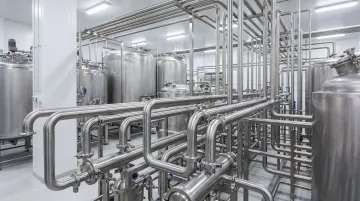 Industrial dairy processing pipeline with tri-clamp sanitary fittings and gasket connections