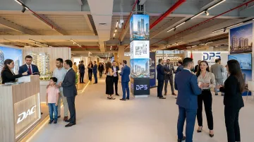 CREDAI property expo floor with multiple developer stalls and homebuyer visitors