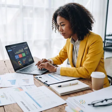 Small business owner reviewing financial reports with an accounting advisor