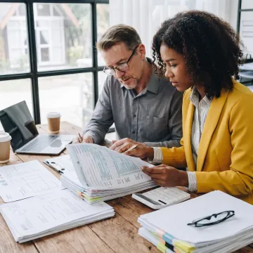 Business owner reviewing corporate tax documents with an advisor