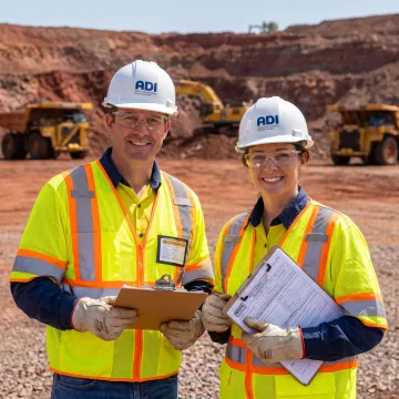 Mining safety consultants reviewing compliance plans at an active mine site