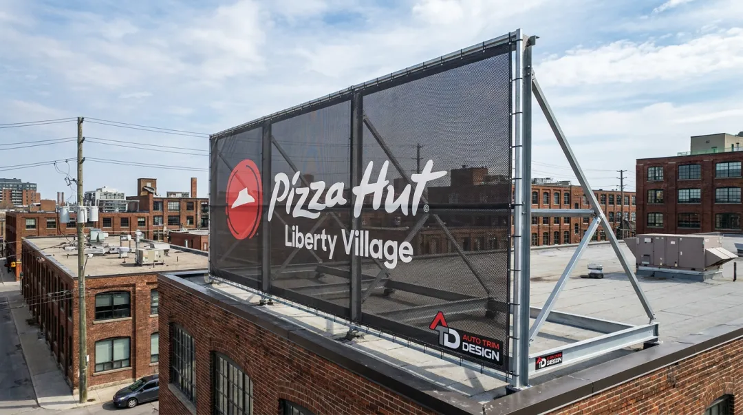 Mesh vinyl rooftop billboard installation for Pizza Hut Toronto storefront
