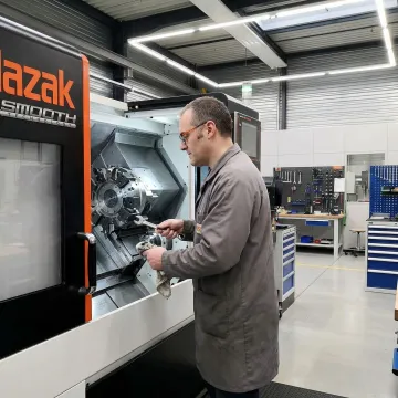 Industrial equipment maintenance technician servicing a CNC machine in a Lancaster, PA manufacturing facility