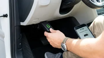 Azuga OBD-II telematics device plugged into vehicle diagnostic port
