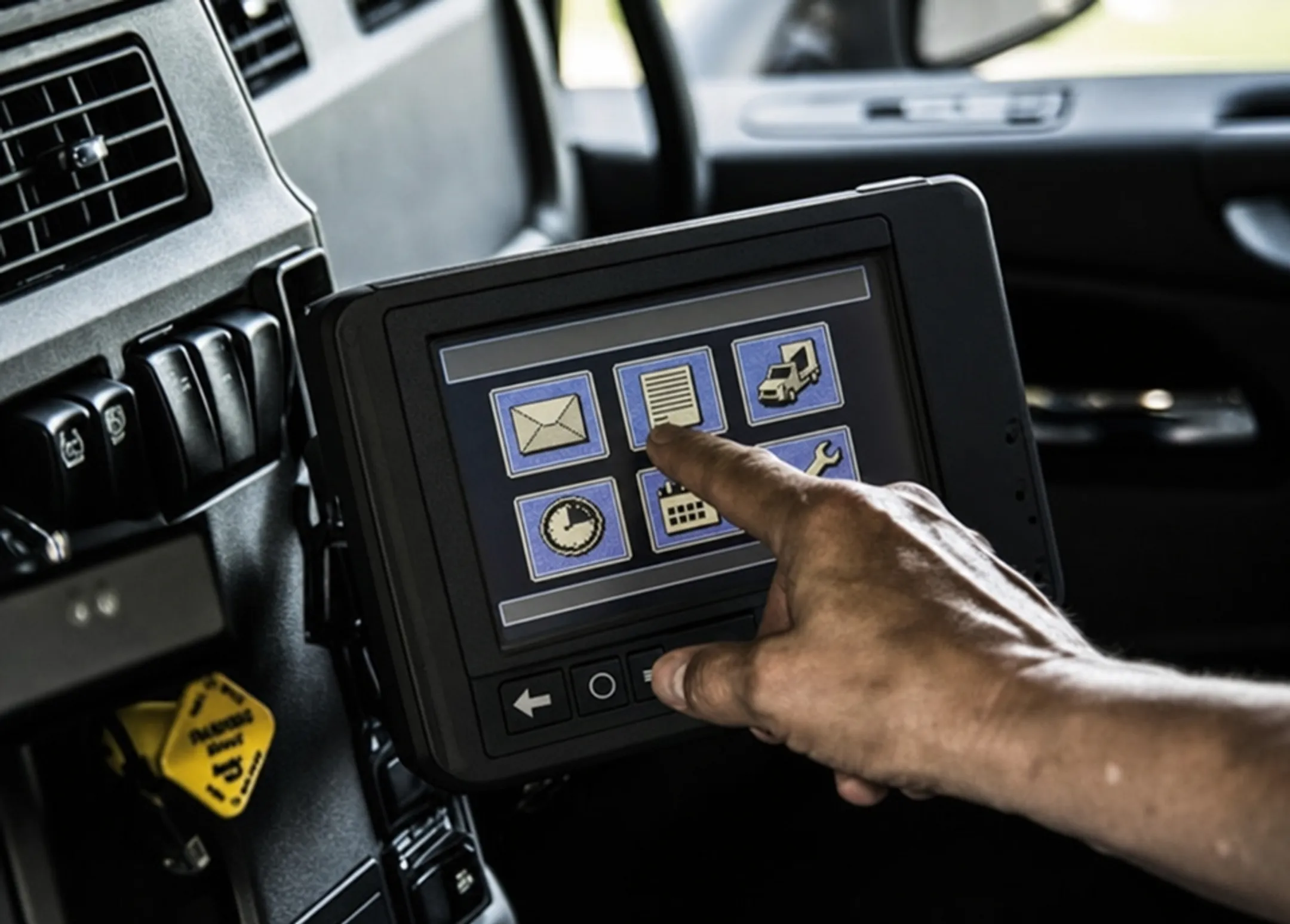 Older commercial truck cab with legacy electronic logging device installed